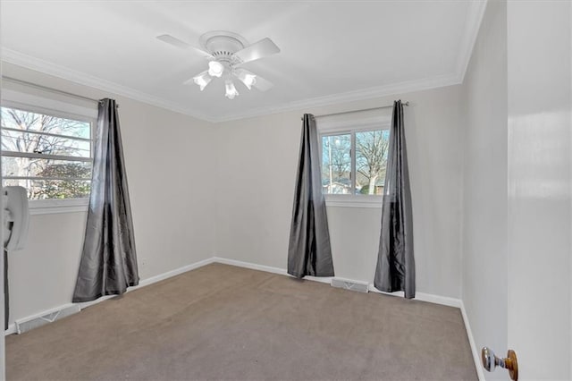 carpeted empty room featuring crown molding and ceiling fan