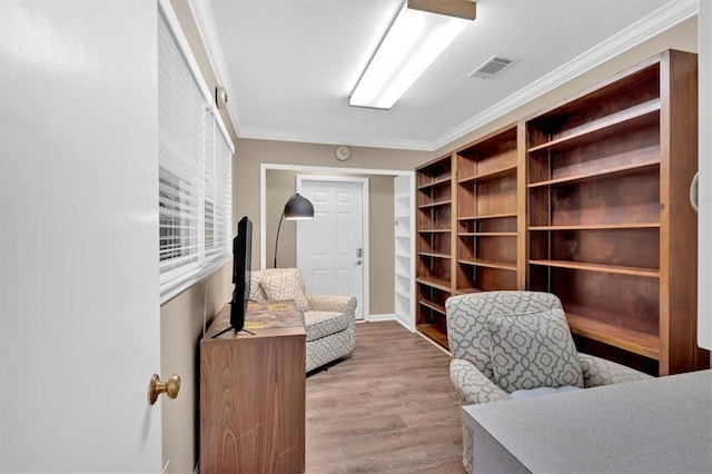 interior space featuring ornamental molding and light wood-type flooring