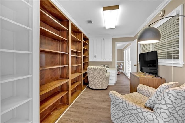 living room featuring ornamental molding and light hardwood / wood-style floors