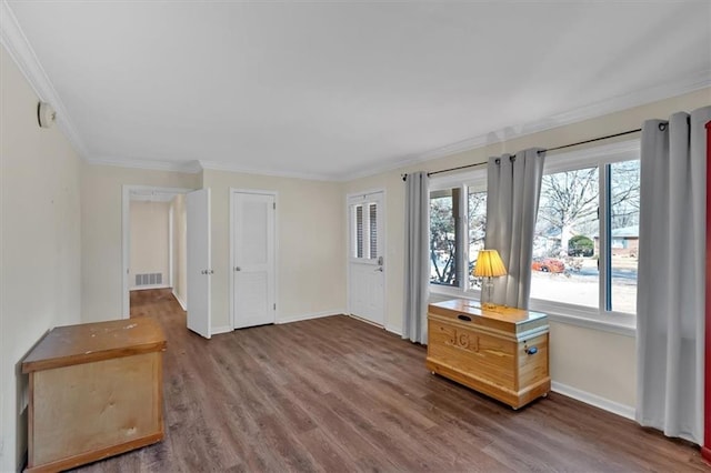 interior space featuring crown molding, plenty of natural light, and dark hardwood / wood-style floors