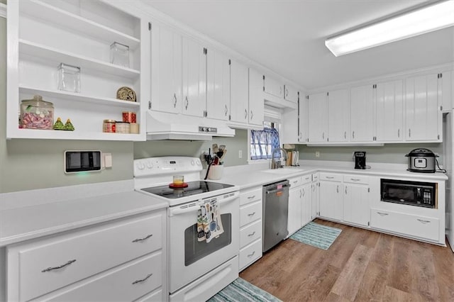 kitchen with sink, electric range, black microwave, white cabinets, and stainless steel dishwasher