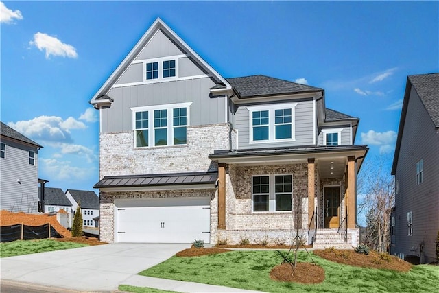 view of front of house with board and batten siding, brick siding, a garage, and driveway