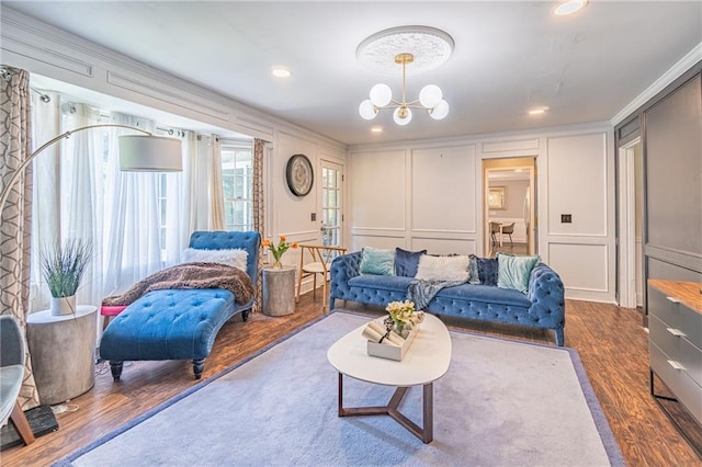 living room with ornamental molding, dark hardwood / wood-style floors, and an inviting chandelier