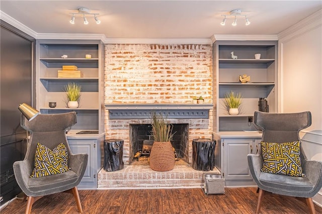 sitting room featuring ornamental molding, dark hardwood / wood-style floors, and a brick fireplace