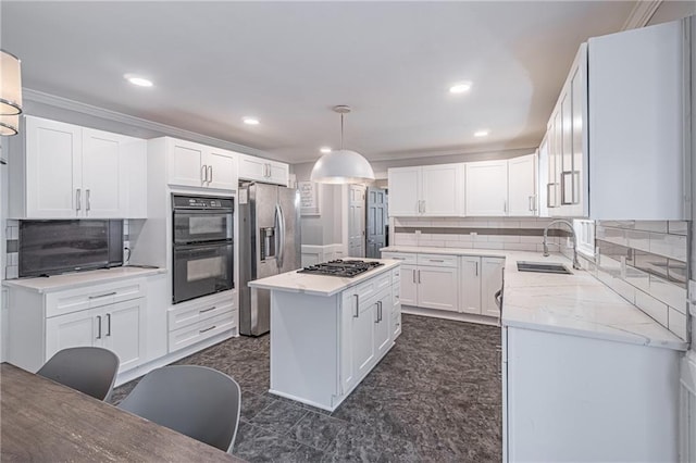 kitchen featuring backsplash, white cabinets, crown molding, decorative light fixtures, and stainless steel appliances