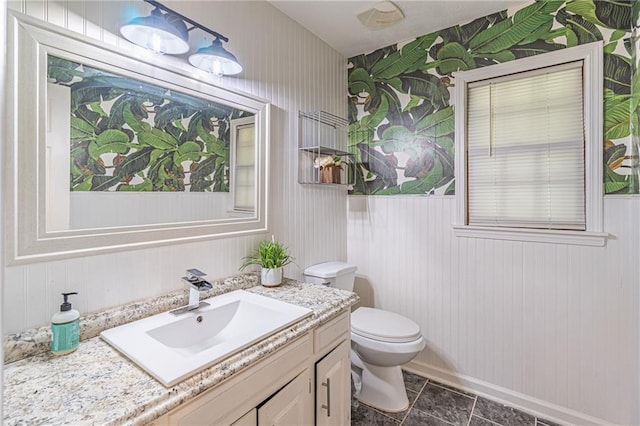 bathroom featuring tile patterned flooring, vanity, and toilet