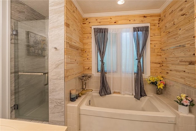 bathroom with shower with separate bathtub, a textured ceiling, crown molding, and wooden walls