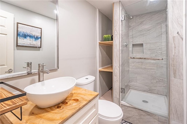 bathroom featuring vanity, toilet, and a shower with shower door