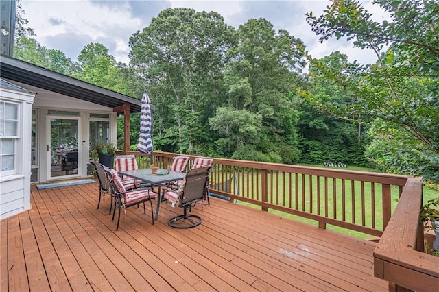 wooden deck featuring a lawn