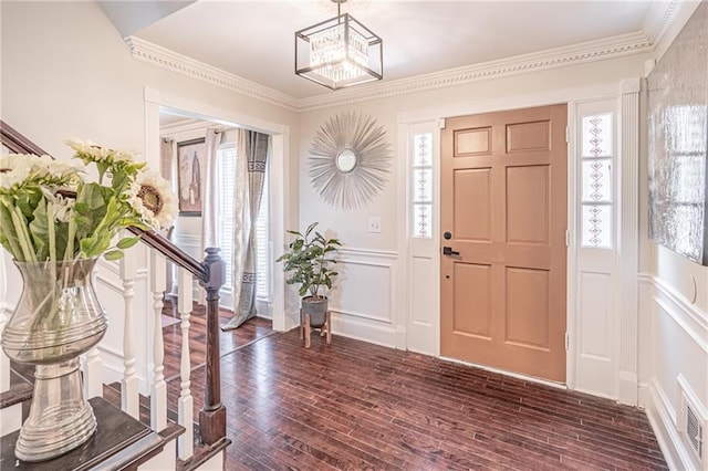 foyer featuring dark hardwood / wood-style flooring and ornamental molding