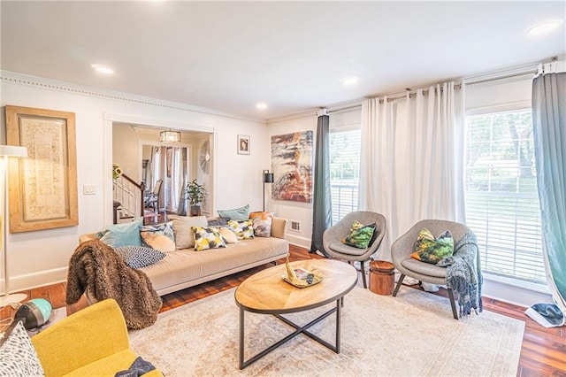 living room featuring wood-type flooring and ornamental molding