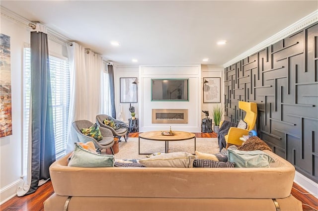 living room with hardwood / wood-style flooring and crown molding