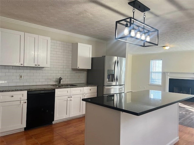 kitchen featuring white cabinetry, hanging light fixtures, stainless steel fridge, sink, and dishwasher