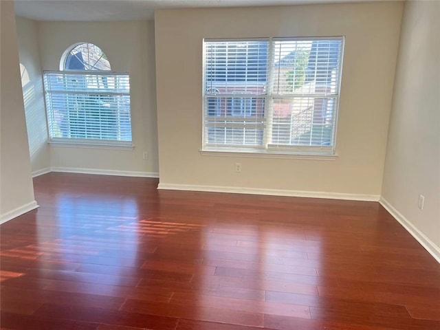 spare room with dark hardwood / wood-style flooring