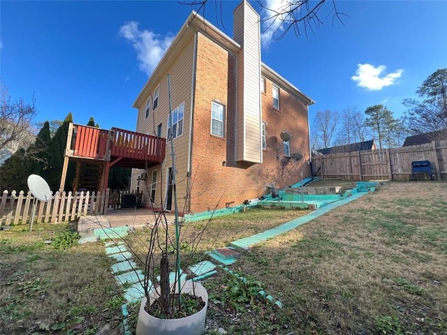 view of side of property featuring central AC unit, a lawn, a wooden deck, and a patio area