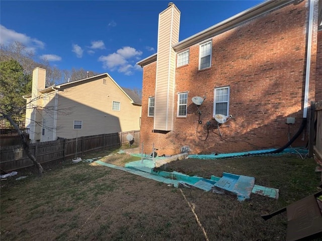 rear view of property featuring a lawn