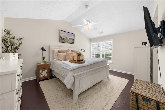 bedroom with baseboards, visible vents, vaulted ceiling, and dark wood-type flooring