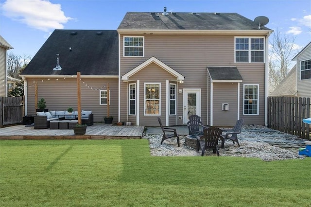 rear view of house featuring an outdoor living space with a fire pit, fence, a lawn, and a wooden deck