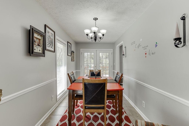 4434 Hidden Oaks Dr, Flowery Branch, GA 30542 - tiled dining area with a chandelier, french doors, and a textured ceiling