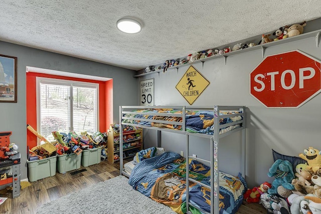 4434 Hidden Oaks Dr, Flowery Branch, GA 30542 - bedroom with wood finished floors and a textured ceiling