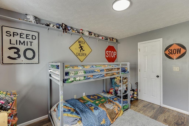 4434 Hidden Oaks Dr, Flowery Branch, GA 30542 - bedroom featuring wood finished floors and a textured ceiling