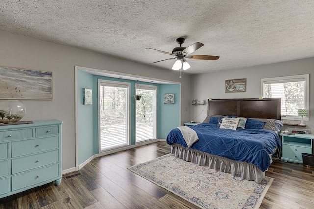 4434 Hidden Oaks Dr, Flowery Branch, GA 30542 - bedroom with multiple windows, access to exterior, dark wood-style floors, and a textured ceiling