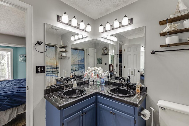 4434 Hidden Oaks Dr, Flowery Branch, GA 30542 - ensuite bathroom with a textured ceiling and double vanity