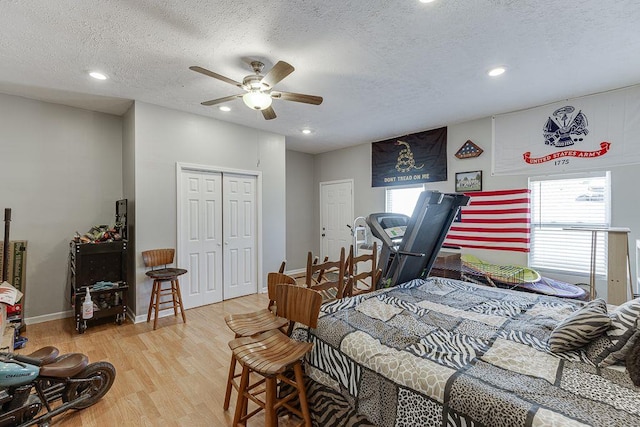 4434 Hidden Oaks Dr, Flowery Branch, GA 30542 - bedroom featuring wood finished floors, multiple windows, a textured ceiling, recessed lighting, and a closet
