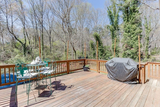 4434 Hidden Oaks Dr, Flowery Branch, GA 30542 - wooden deck with a grill and outdoor dining space