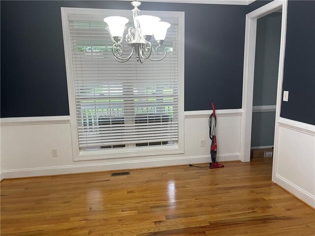 details featuring crown molding, wood-type flooring, and a stone fireplace