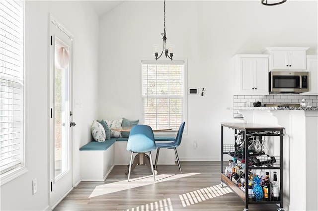 dining area featuring hardwood / wood-style flooring and a notable chandelier