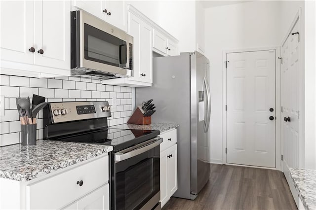 kitchen featuring white cabinetry, light stone countertops, and stainless steel appliances