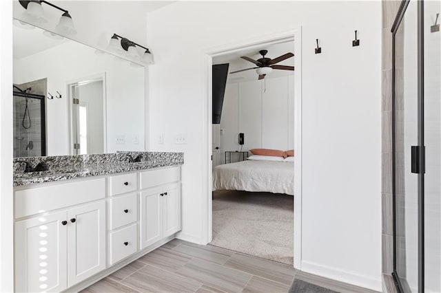 bathroom featuring vanity, ceiling fan, and a shower with shower door