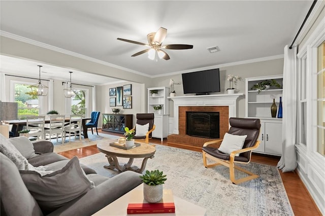 4504 Reva Way NE, Marietta, GA 30066 - living room featuring crown molding, wood finished floors, a ceiling fan, and a brick fireplace