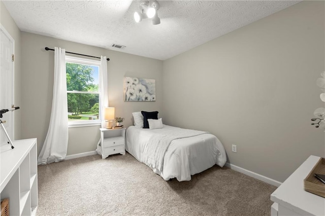 4504 Reva Way NE, Marietta, GA 30066 - bedroom with baseboards, a textured ceiling, and light carpet