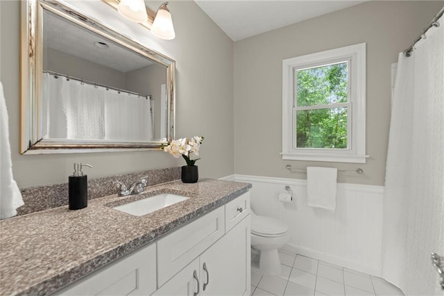 4504 Reva Way NE, Marietta, GA 30066 - bathroom with vanity, a wainscoted wall, toilet, and tile patterned floors