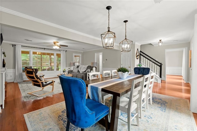 4504 Reva Way NE, Marietta, GA 30066 - dining area featuring wood finished floors, stairs, a chandelier, ornamental molding, and wainscoting