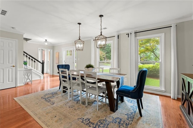 4504 Reva Way NE, Marietta, GA 30066 - dining room with stairway, ornamental molding, wood finished floors, a chandelier, and baseboards