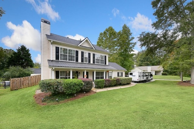 view of front facade with a front lawn and covered porch