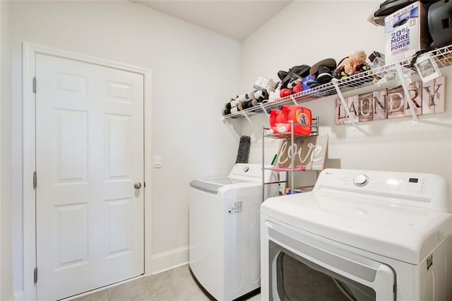 42 Citrine Way, Acworth, GA 30101 - laundry room with washing machine and clothes dryer, baseboards, and light tile patterned floors