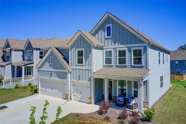 42 Citrine Way, Acworth, GA 30101 - view of front of home featuring board and batten siding, a porch, driveway, a garage, and a front lawn
