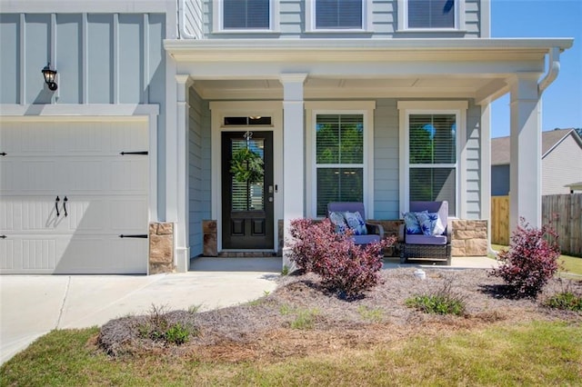42 Citrine Way, Acworth, GA 30101 - view of exterior entry featuring covered porch, stone siding, driveway, and an attached garage