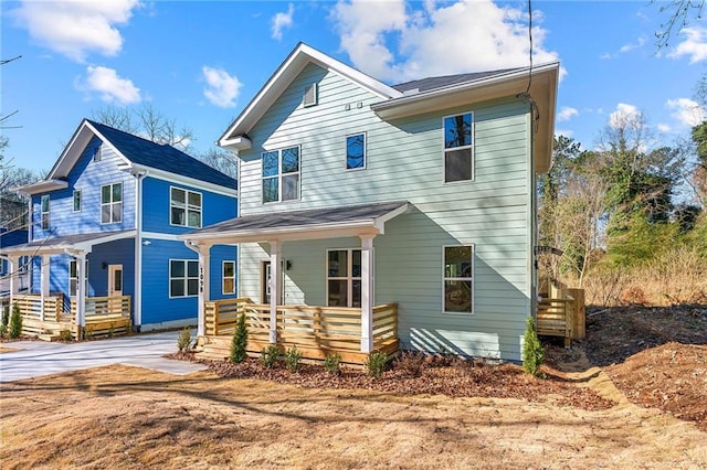 view of front of house featuring a porch and concrete driveway