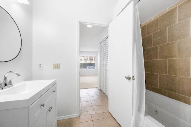 full bathroom with a washtub, vanity, and tile patterned flooring