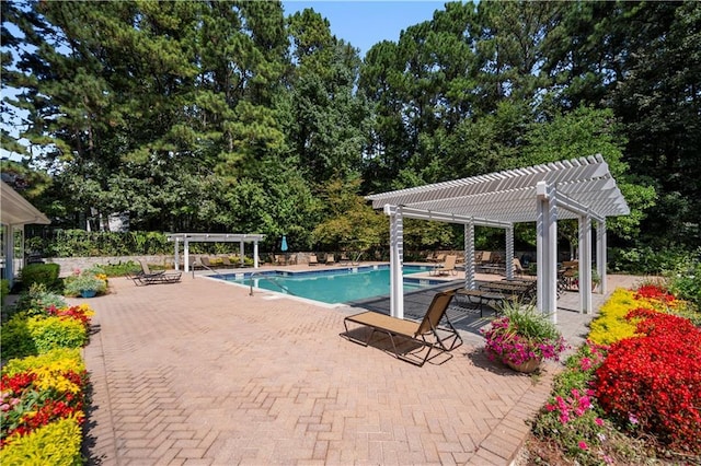 view of swimming pool featuring a patio area, a fenced in pool, and a pergola