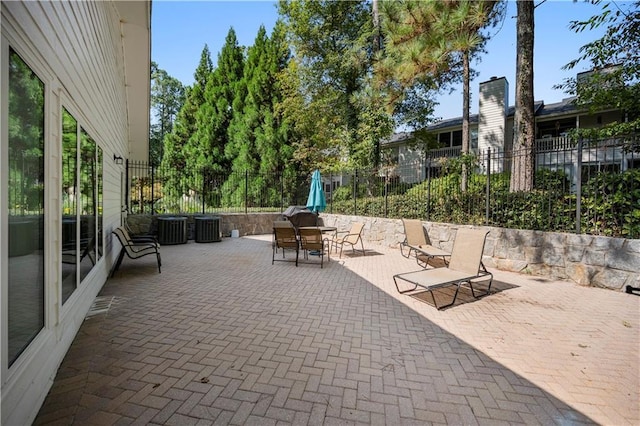 view of patio / terrace featuring cooling unit and fence