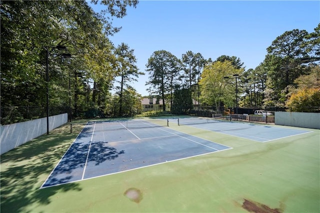 view of tennis court with fence