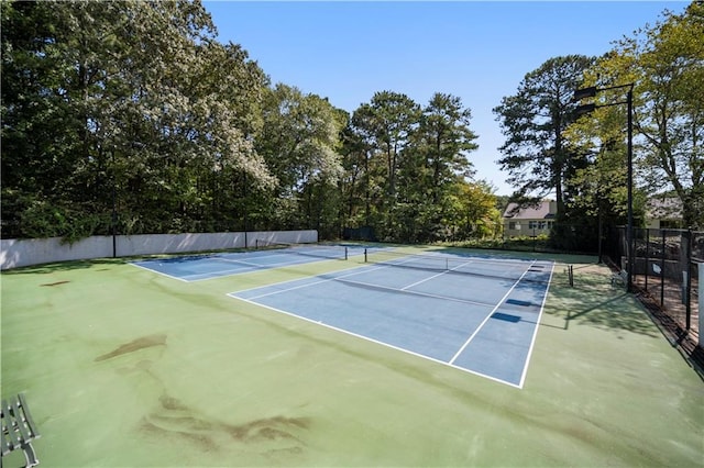 view of tennis court with fence