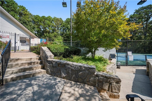 exterior space featuring fence, a patio, and a gate