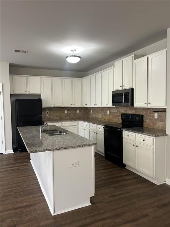 kitchen featuring dark wood-style floors, black appliances, visible vents, and white cabinets